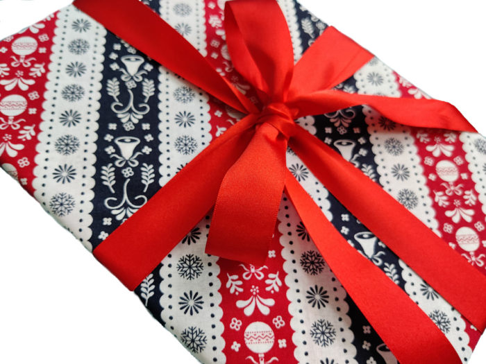 Christmas Present wrapped in Red, White and Navy Blue Scandi Stripe Fabric Gift Wrap and Red Ribbon