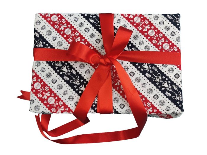 Christmas present wrapped in Red, White and Navy Blue Scandi Stripe Fabric Wrapping and Red Ribbon